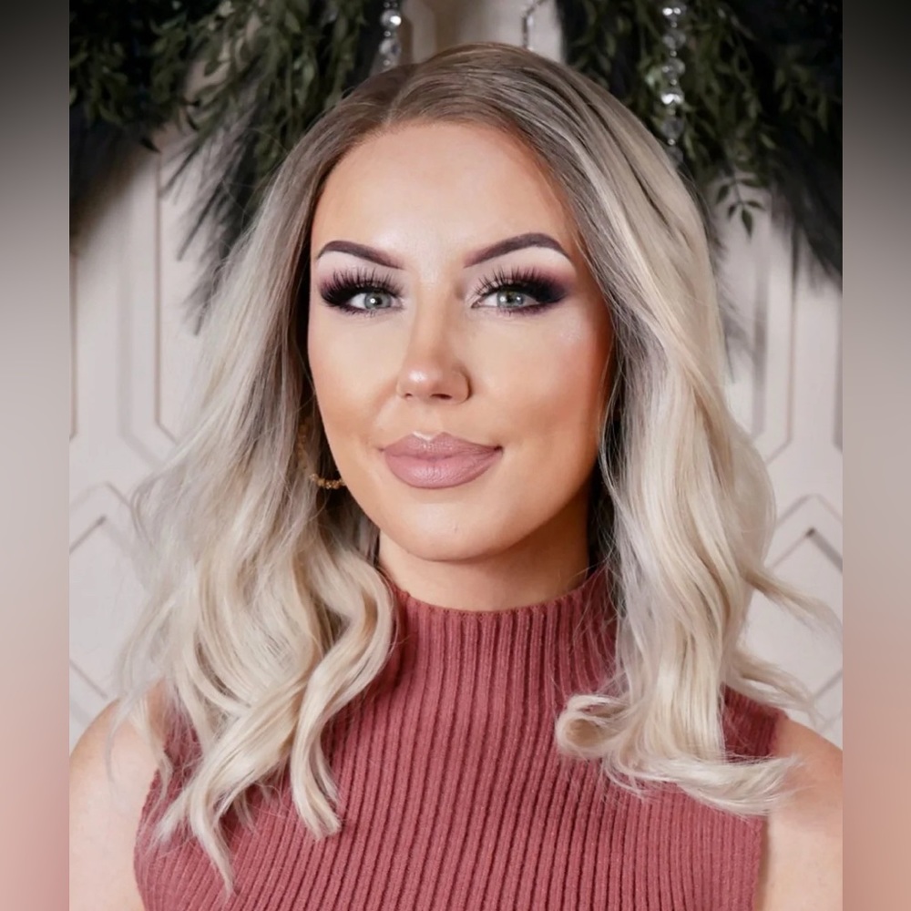 Creamy blonde wig with smudged root and light tapering throughout